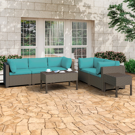 The Keys outdoor patio furniture is set up in a backyard area. It has blue cushion covers.