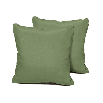 Two green square pillows on a white background