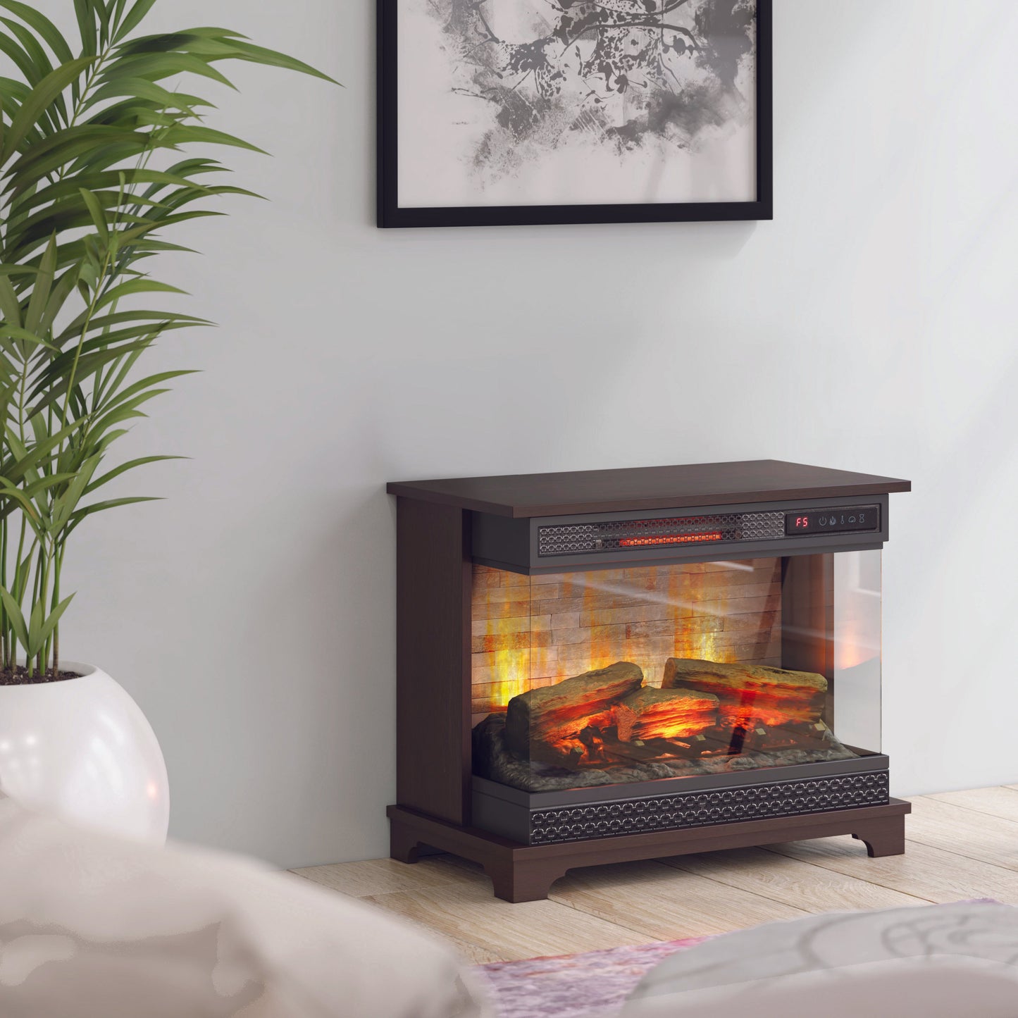 Electric fireplace insert in a living room setting with a plant and lamp.