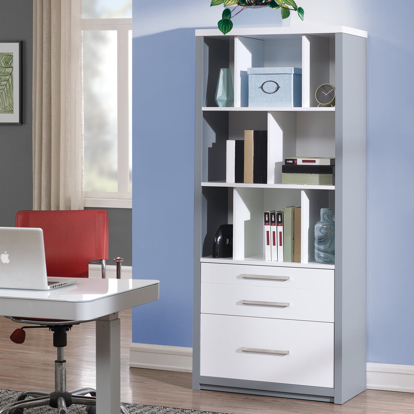 White bookshelf with shelves and drawers in a room with a desk and chair.