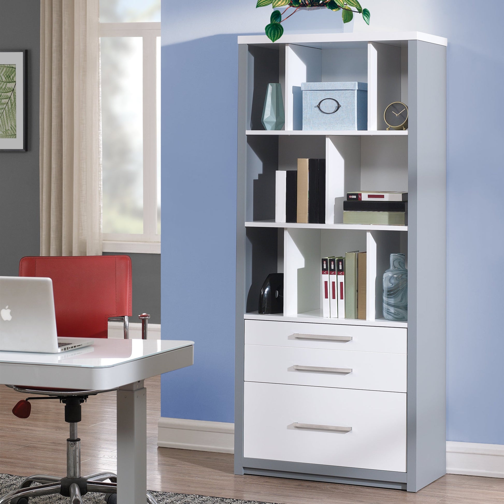 White bookshelf with shelves and drawers in a room with a desk and chair.