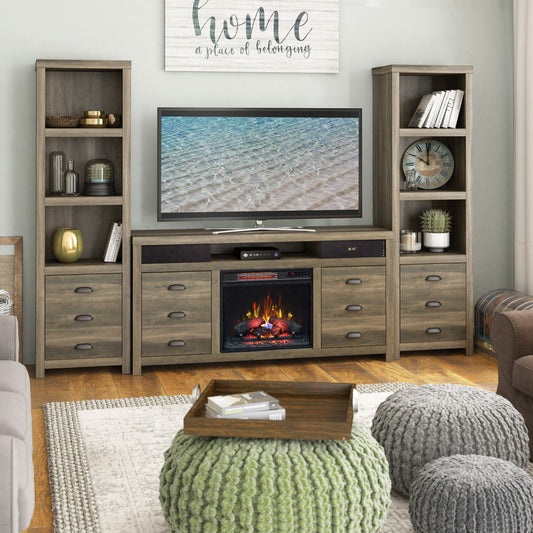 Living room with a fireplace console, TV, and decorative items.