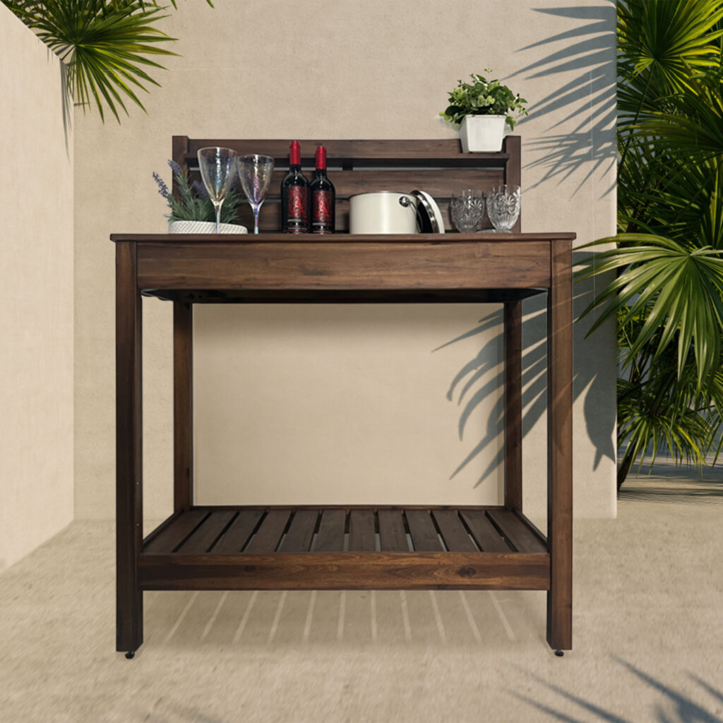 A potting bench has drinks and party materials - it sits on an outdoor patio.